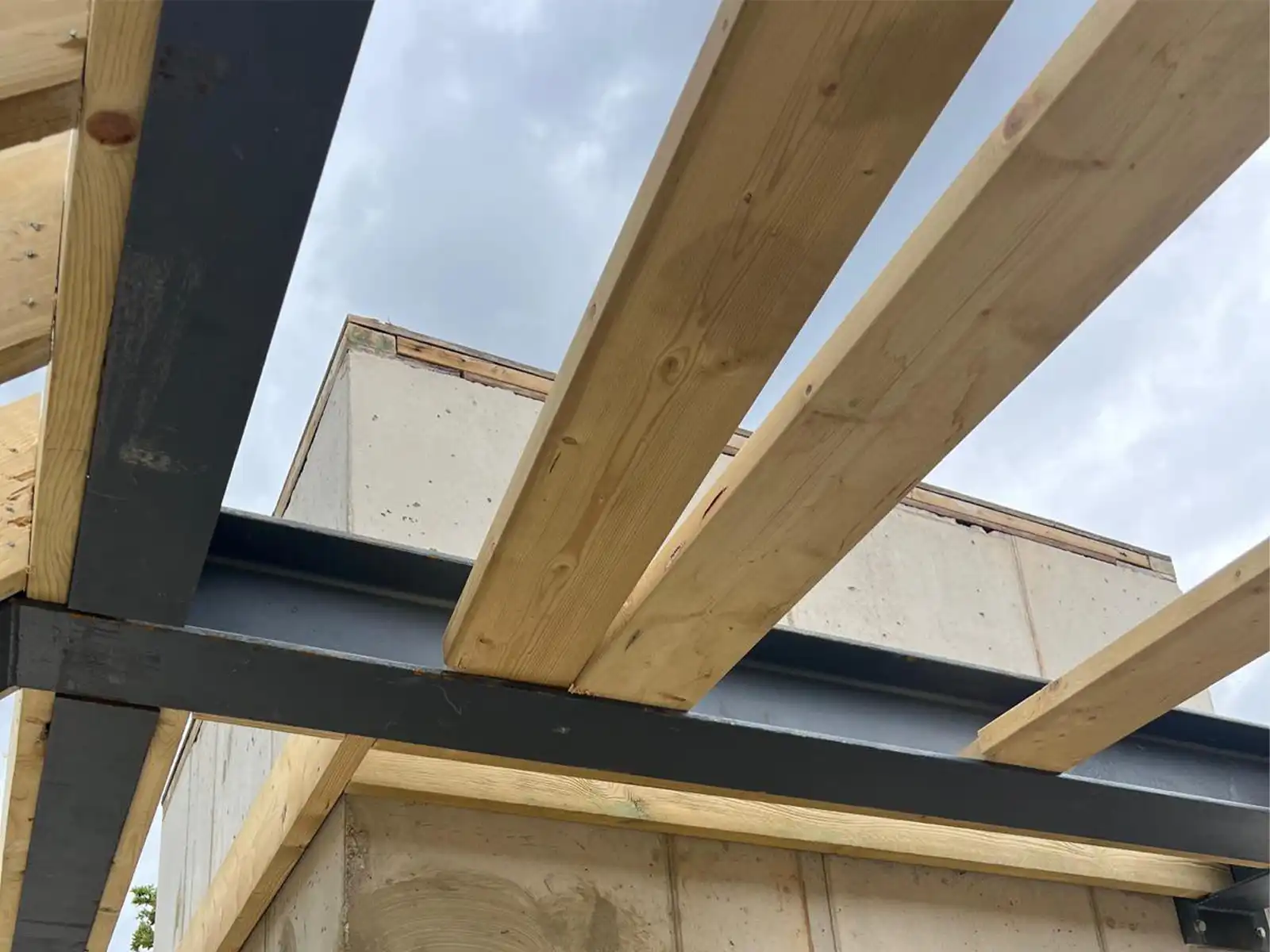 Structural Engineer overseeing implementation of RC Frame with RSJ crank Steels on construction site, ensuring precise and efficient structural integration - following our Structural Drawings and Calculations