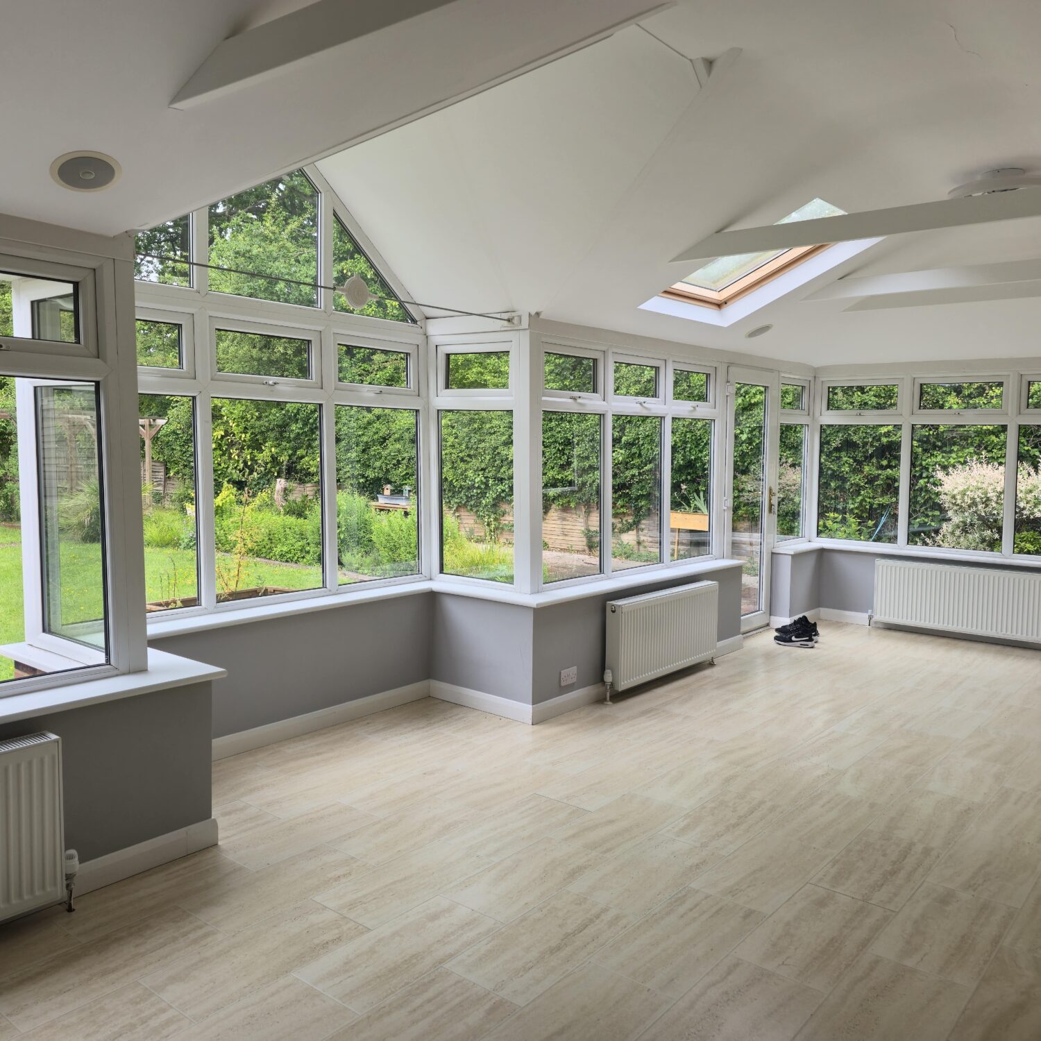 Modern conservatory with building regulations compliant glazing and integrated heating system showing radiators installed