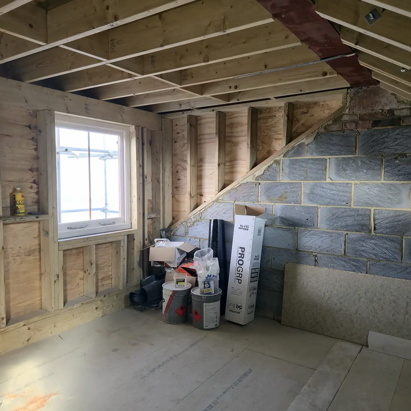 Dormer loft conversion showing timber joists and steel beam inserted into the party wall during structural works