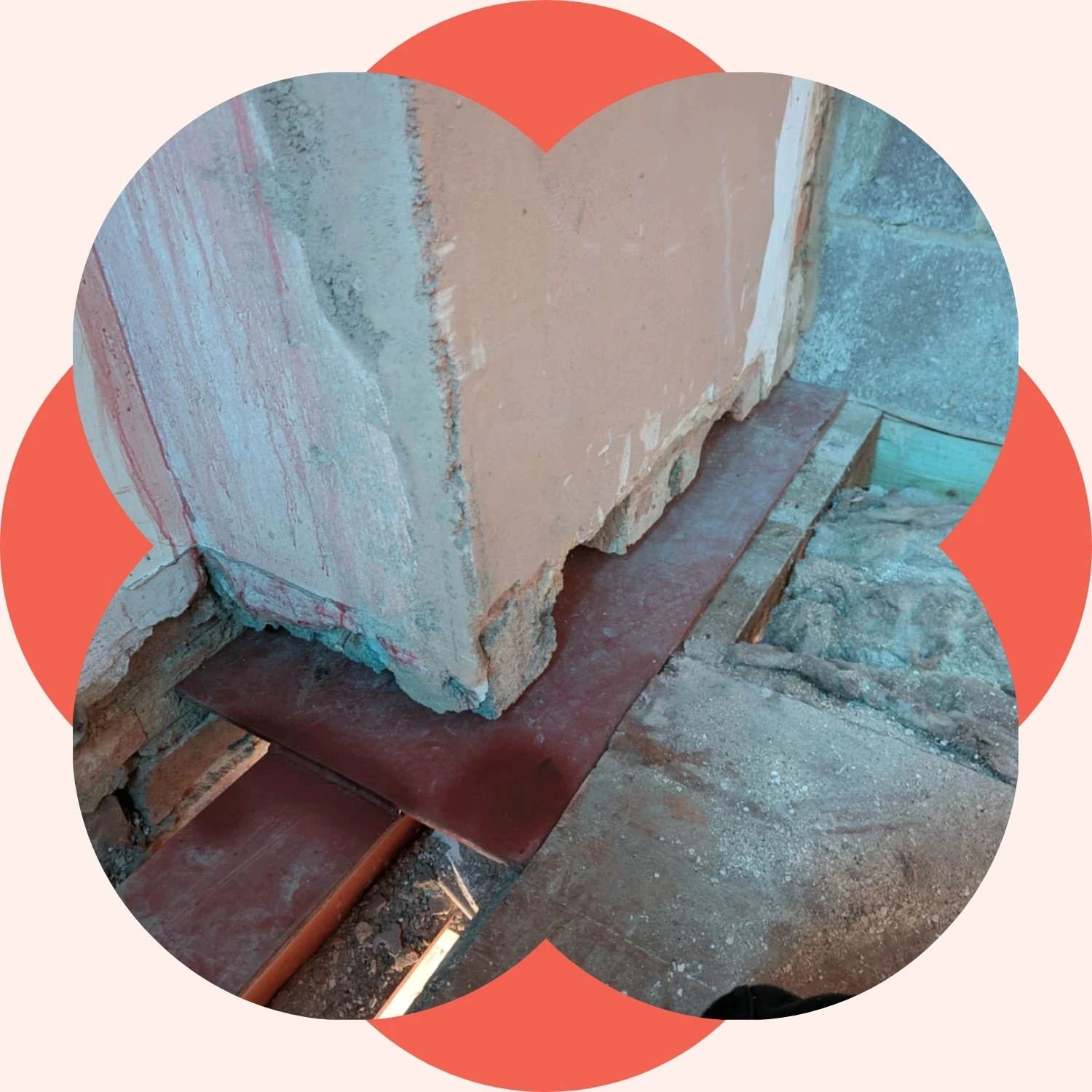 Close-up of steel support plates beneath a partially removed chimney breast during chimney breast removal work.